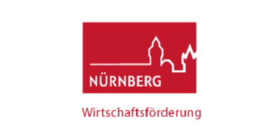  Logo der Wirtschaftsförderung Nünrberg ist ein rotes Rechteckt mit dem Umriss der Stadt Nürnberg. Deutlich sieht man die Burg.  