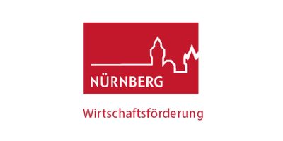  Logo der Wirtschaftsförderung Nünrberg ist ein rotes Rechteckt mit dem Umriss der Stadt Nürnberg. Deutlich sieht man die Burg.  