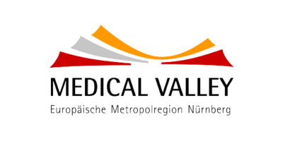 Logo von Medical Valley ähnelt einem Sonnenaufgang. Verschied farbige Balken in rot-orangefarbenden Tönen sind übereinander gelegt