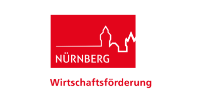 Logo der Wirtschaftsförderung Nünrberg ist ein rotes Rechteckt mit dem Umriss der Stadt Nürnberg. Deutlich sieht man die Burg.  